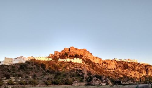 a mountain with houses on top of it at MARIANS in Salobreña