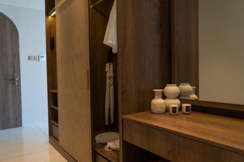 a bathroom with two white vases on a wooden counter at Royal Avila Boutique Resort in Senggigi 