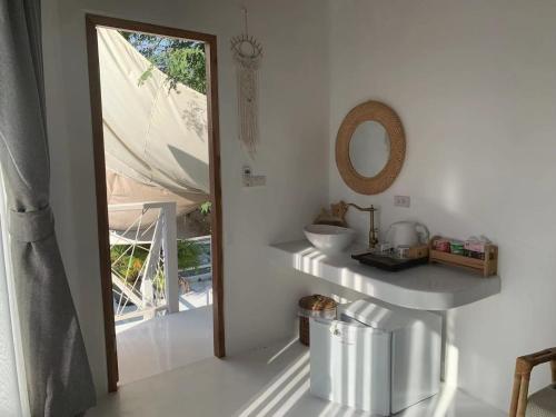 a bathroom with a sink and a mirror and a window at lory‘s home in Bangkok