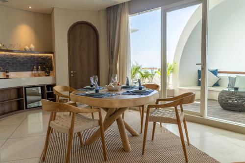 a dining room with a table and chairs in a room at Royal Avila Boutique Resort in Senggigi 
