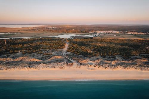 an aerial view of a beach and the ocean at AlmaLusa Comporta in Comporta