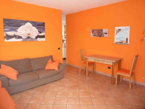 a living room with a couch and a table at Casa Malandrino in Porto Valtravaglia