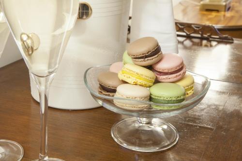 a glass bowl filled with different types of pastries at Relais Fra' Lorenzo in Verona