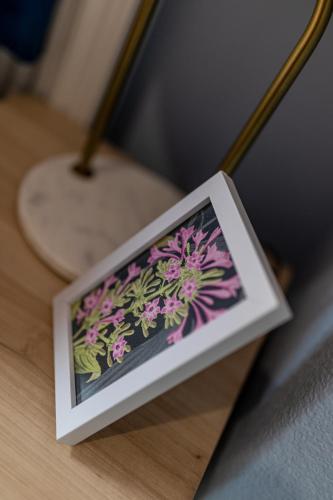 a picture of purple flowers on a table at Charles Alexander Short Stay - Botanical House in Cleveleys