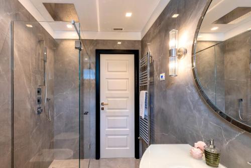 a bathroom with a shower and a sink and a mirror at Genteel Home Prato in Prato