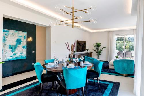 a dining room with a table and blue chairs at Genteel Home Prato in Prato