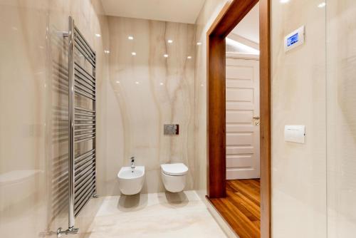 a bathroom with a toilet and a sink in it at Genteel Home Prato in Prato