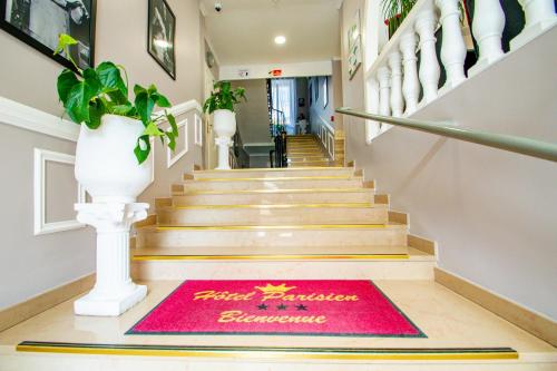 a red welcome mat on the floor of a staircase at H&ocirc;tel Parisien in Nice