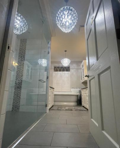 a bathroom with a shower and a glass door at Greystone WaterFront Lux in Saint John