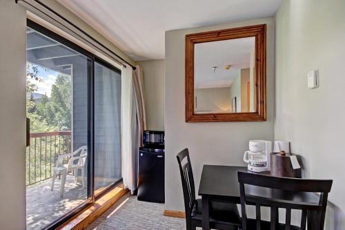 a dining room with a table and a mirror at Studio Apartment in Breckenridge