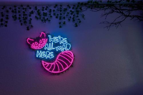 a neon sign that says here are all around here at 2 King Beds / Hot Tub / BBQ / Hiking / Fire Pit in Littleton