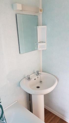 a bathroom with a white sink and a mirror at Robin hood retreat 2 bedroom chalet Free parking in Nottingham