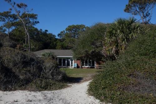 a house with a dirt road in front of a house at ALWAYS TURTLE CRAWL home in Jekyll Island