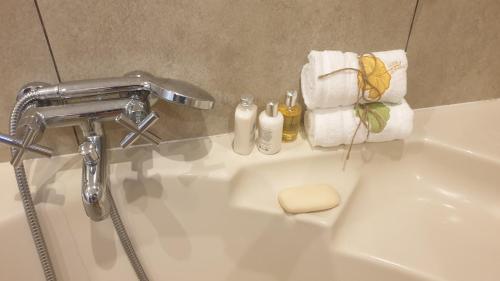 a bathroom sink with a faucet and towels on it at Immaculate 3-Bed House in Bristol in Bristol