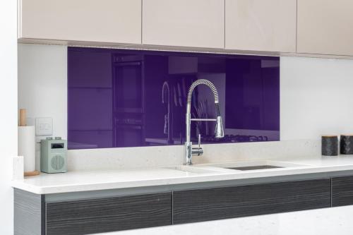 a kitchen counter with a sink and purple cabinets at Fabulous House - Only 10 minutes walk to Roman Baths in Bath