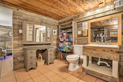 a bathroom with a fireplace and a toilet and a sink at Waterfront Guadalupe River Lodge Home with Dock! in Seguin