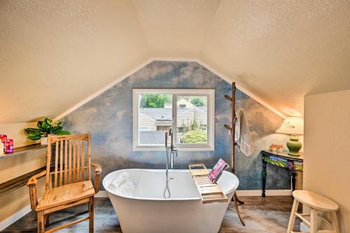 een badkamer op zolder met een bad en een stoel bij Seattle Vacation Rental - Balcony, Near Parks! in Seattle