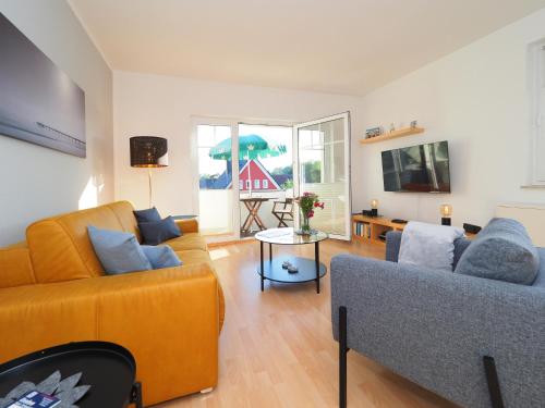 a living room with two couches and a fireplace at Ferienwohnung "Sonnenblick" in Ahlbeck