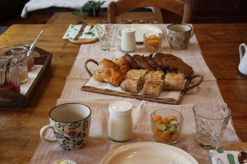 a table with a tray of food and cups on it at L'Atterrissage in Santes