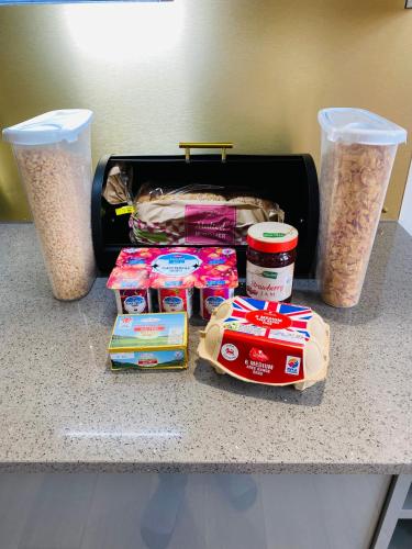 a counter with some food and a box of food at Luxury 1 Bedroom Duplex with Free Parking in Plymouth