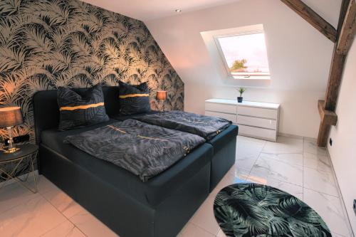 Postel nebo postele na pokoji v ubytování Ferienwohnungen im Palmengarten - 70 qm