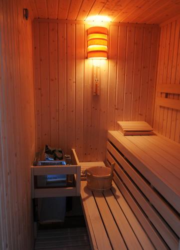 a small sauna with a light on the wall at Boutique Hotel Sudetia - Medical & SPA in Świeradów-Zdrój