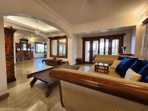 a large living room with a couch and a table at Villa 17 Luisa by the Sea in Madgaon