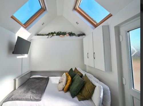 um quarto com uma cama num quarto com janelas em Lincoln Holiday Retreat Little House em Lincoln