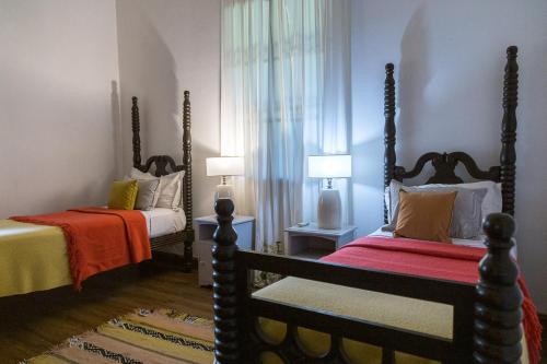 1 Schlafzimmer mit 2 Betten und einer roten Decke in der Unterkunft Pristine Residence Iguazú in Puerto Libertad