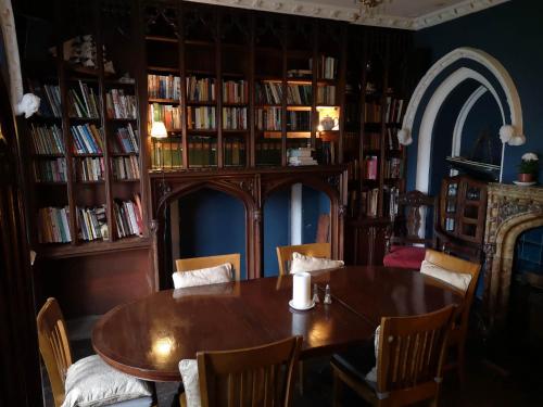 a dining room with a table and some books at The Priory Hotel in Louth