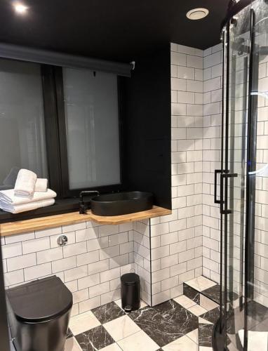 a bathroom with a sink and a shower at The Baltic Hotel in Liverpool