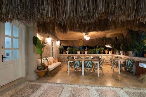 a restaurant with tables and chairs and a bar at Mono Lıfe Alaçatı in Alacati