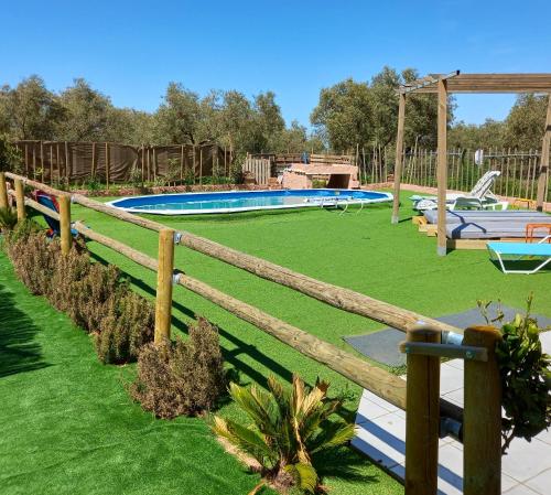 a wooden fence in front of a swimming pool at 5 bedrooms villa with private pool enclosed garden and wifi at Villanueva del Trabuco in Villanueva del Trabuco