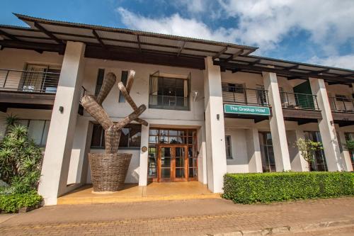 a building with a tree in front of it at Graskop Hotel in Graskop
