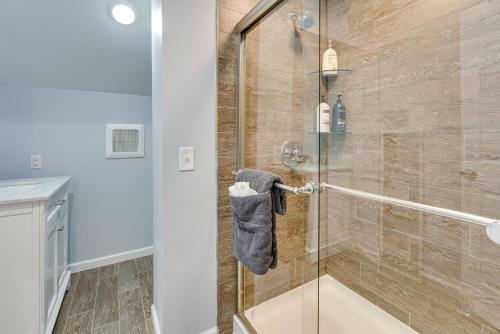 a bathroom with a shower with a glass door at Renovated Victorian House about 7 Miles to Downtown! in Detroit