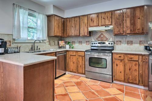 a kitchen with wooden cabinets and a stove top oven at San Marcos Vacation Rental 4 Miles to Downtown! in San Marcos