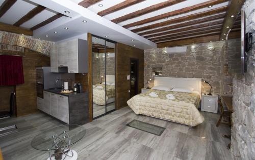 a bedroom with a bed and a stone wall at Villa Domina in Split