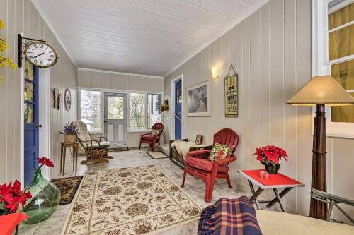 a living room with a clock on the wall at Hadley Vacation Rental 24 Mi to Springfield! in Hadley