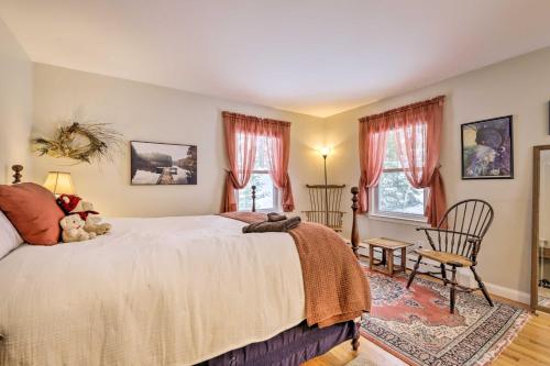 a bedroom with a large bed and two windows at Hadley Vacation Rental 24 Mi to Springfield! in Hadley