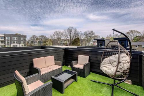 a patio with chairs and a swing on a roof at Modern ATL Getaway Less Than 3 Mi to Mercedes-Benz Stadium in Atlanta