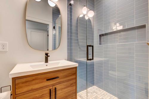 a bathroom with a sink and a mirror at Modern ATL Getaway Less Than 3 Mi to Mercedes-Benz Stadium in Atlanta