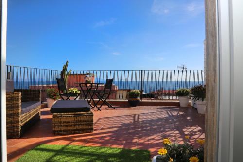 a patio with a view of the ocean at B&B La Dimora di Nonno Lucio in Pozzuoli