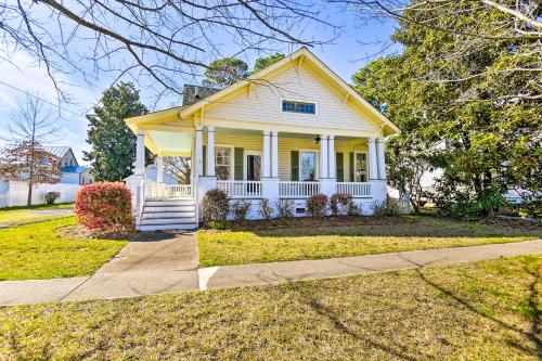 a yellow house with a porch and a driveway at Edenton Vacation Rental with Patio Walk Downtown in Edenton