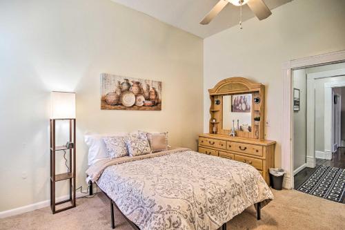 a bedroom with a bed and a dresser in it at Bright Augusta Vacation Rental, 2 Mi to Riverwalk! in Augusta