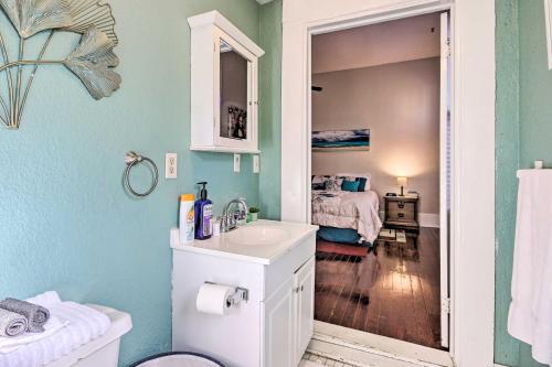 een badkamer met een wastafel en een kamer met een bed bij Bright Augusta Vacation Rental, 2 Mi to Riverwalk! in Augusta