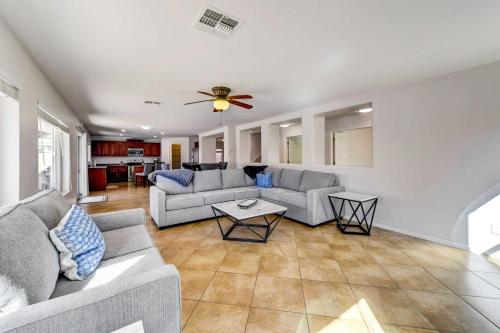 a living room with two couches and a ceiling fan at Putting Green, Pool and Spa Home in Queen Creek! in Queen Creek