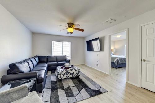 a living room with a couch and a ceiling fan at Putting Green, Pool and Spa Home in Queen Creek! in Queen Creek