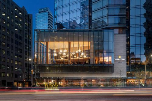 a tall glass building with a lot of windows at Shangri-La Toronto in Toronto