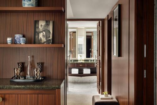 a hallway leading to a bathroom with a sink at Shangri-La Toronto in Toronto