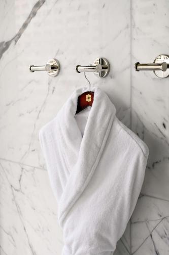 a white towel hanging on a towel rack in a bathroom at Shangri-La Toronto in Toronto